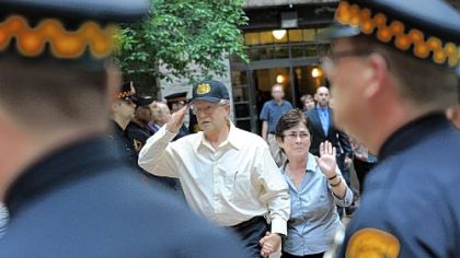 Paul and Julia "Sue" Sciullo, parents of Officer Paul Sciullo III, acknowledge the police line outside the courthouse.
