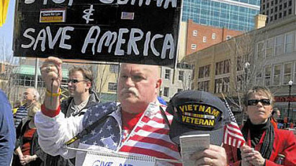 Russ Hall, 68, of Lawrence County, and other tea party supporters take part in the tax day rally in Market Square on Friday.