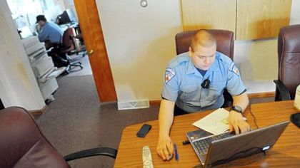 Emergency medical technician Rick Lagamba catches up on paperwork during his shift at the Robinson Emergency Medical Service station.
