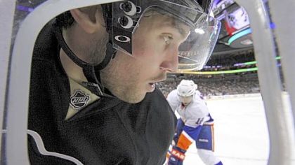 Penguins' Eric Tangradi, left, works in the corner against New York Islanders' Josh Bailey, in Pittsburgh, Wednesday, Feb. 2, 2011.