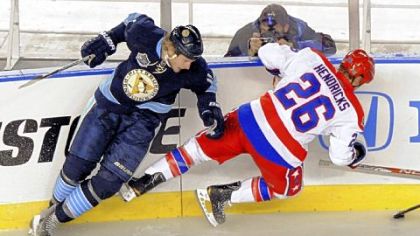 The Penguins' Jordan Staal checks the Capitals' Matt Hendricks along the boards in the first period at the Winter Classic at Heinz Field last night.