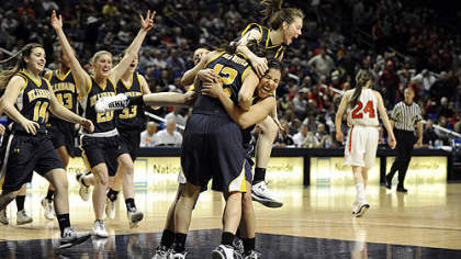 Mt. Lebanon's Madison Cable jumps onto teammate Kelly Johnson and Liz Tommasi after defeating Archbishop Carroll in the PIAA Class AAAA girls basketball championship at the Bryce Jordan Center in University Park, Pa. Friday.