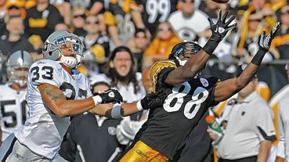 Emmanuel Sanders stretches out for a pass against Oakland. Including playoffs, Sanders has 32 catches this season -- 16 of them in the past four games.