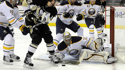 Buffalo's Ryan Miller stops a shot in front of Penguins Dustin Jeffrey.