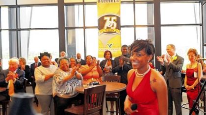 Taylor Randall, one of seven graduating seniors at The Neighbohood Academy, is applauded.