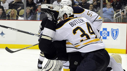 Penguins forward Chris Kunitz is upended by Sabres defenseman Chris Butler in the third period of Tuesday's game at Consol Energy Center.
