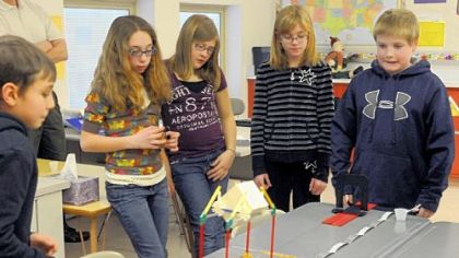 From left, fifth-graders Justin Mondak, Kylee Aquilante, Olivia Dugan, Julianna Rohl and David Hoffman watch as they test their car during a science experiment.