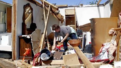 Deborah Dulow cleans up her father's house in Askewville, N.C., on Sunday, after a tornado moved through the area Saturday.