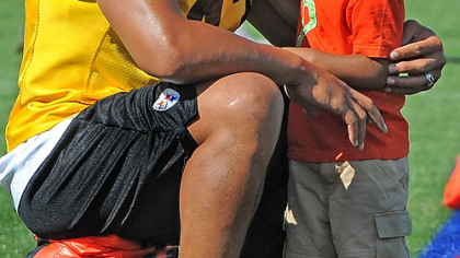 Troy Polamalu laughs with his son between workouts at training camp Tuesday at Saint Vincent College in Latrobe.