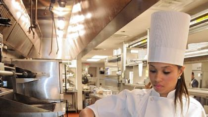 Andora Restaurant executive chef Elise Wims is shown plating her signature dish, Pesto Seared Scallops, with Sauteed Chard and roasted Cemuy tomatoes, in a Shallot Burerre Blanc.