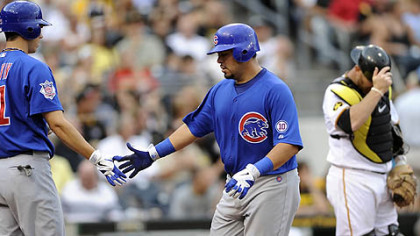 The Cubs' Geovany Soto, center, is congratulated by teammate Tyler Colvin after hitting a home run against the Pirates in the third inning of Thursday's game at PNC Park. Pirates catcher Mike McKenry adjusts his helmet.