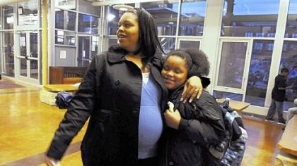 Janice Watkins drops off her daughter, Gracelyn, 8, and son, Gerald, 13, not pictured, for evening classes at the Sara Heinz Center. Ms. Watkins, who is pregnant with twins, takes a drug known as 17P. The FDA recently gave a drug company exclusive rights to produce the drug, dramatically raising the cost.