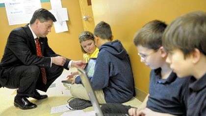 Lt. Gov. Jim Cawley observes fifth-graders, from left, McKenna Battista, 11, of Pittsburgh, Dwayne Rankin, 11, of West Allegheny, Jonathan Knoll, 11, and Kyle Kowalewski, 10, of Pittsburgh, as he tours the Propel Montour charter school in Kennedy last Thursday.