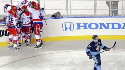 The Capitals celebrate a goal by Eric Fehr in the third period as the Penguins' Sidney Crosby skates by at the Winter Classic at Heinz Field yesterday.
