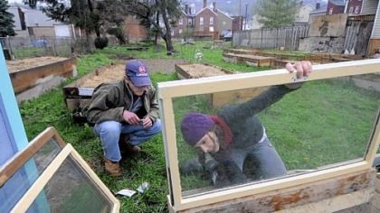 Ben Gould, 16, a volunteer from Fox Chapel, and Amy Rappa, the Gardens of Millvale coordinator, put together cold frames for the gardens on Butler Street in Millvale.