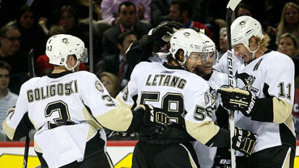 Penguins forward Chris Kunitz, No. 14, celebrates a third period goal with teammates Alex Goligoski Kris Letang and Jordan Staal during Wednesday's game against the Canadiens at the Bell Centre in Montreal.