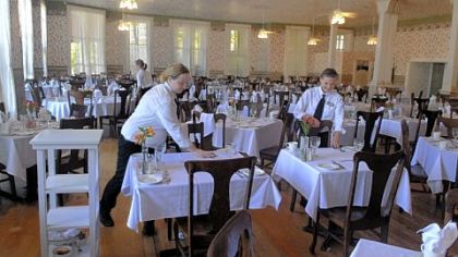 Melanie Chmura of New Castle, in the background, Ashley Johnson of Jamestown, N.Y., center, and Mary Richardson of Findley Lake, N.Y., set tables for dinner in the Athenaeum Hotel. All three work as waitstaff for special events.