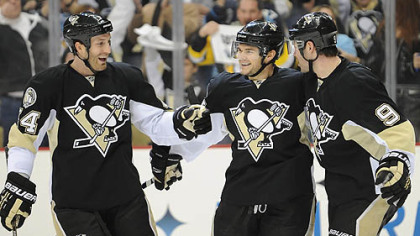 Penguins forward Chris Kunitz, center, celebrates a goal with defenseman Brooks Orpik, left and Pascal Dupuis in the first period of Wednesday's game against the Lightning at Consol Energy Center.