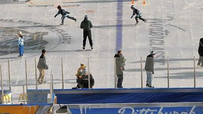 As skaters take to the ice for the last time, Heinz Field workers dismantle the on-field rink Sunday morning after the NHL Winter Classic.