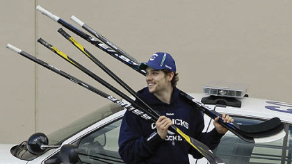 Vancouver Canucks left wing Mason Raymond carries sticks as he arrives at practice for the NHL Stanley Cup Finals, Friday, June 3, 2011, in Vancouver, British Columbia. The Canucks host the Boston Bruins in Game 2 of the best-of-seven games series on tonight. The Canucks lead 1-0.