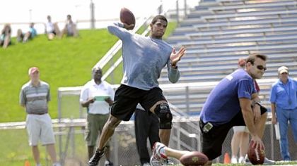 Terrelle Pryor worked out for more than a dozen NFL scouts at his pro day Saturday at Hempfield High School. His agent, Drew Rosenhaus, is at right.