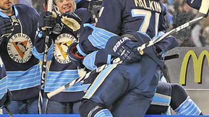 Evgeni Malkin leaps into the bench after scoring in the second period against the Capsitals last night at Heinz Field.