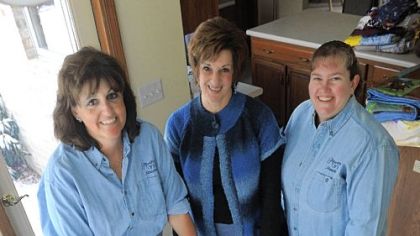 From left, Wendy Kovach of Valencia, Jane Sorchilla of Carnegie and Lisa Suppo of Valencia pose for a portrait with a quilt they created at Mrs. Kovach's home last month.