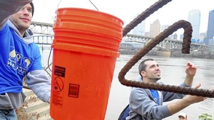 Volunteers Jan Paul, left, 25, of Friendship, Trey Goff, 22, of Morgantown, W.Va., and Duquesne University freshman Derek Schmack, 19, retrieve water from the Monongahela River during the fourth annual "water walk" on the South Side on Saturday. About 300 participants carried 5-gallon buckets of water from the Monongahela River to Duquesne University's campus to experience what many people do to survive during the global water crisis.