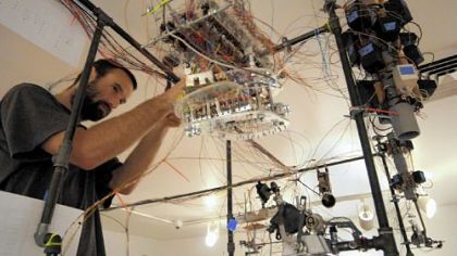 Adam Shreckhise assembles his installation art, "POM (Portrait of the Artist as a Machine)," a complicated maze of circuits and machine parts that will create its own art when completed. Installations are in progress for the 2011 Pittsburgh Biennial at Pittsburgh Center for the Arts, Shadyside.