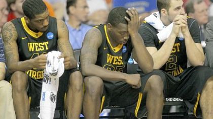 West Virginia's John Flowers, left, Darryl Bryant and Cam Thoroughman watch the final moments of Saturday's loss.