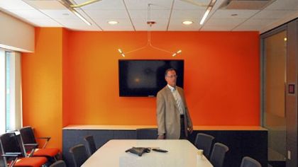 Gary Saulson, director of corporate real estate for PNC Financial Services Group, in the "Frontal Cortex" conference room on the 19th floor of Two PNC Plaza. It uses LED lighting from above, and you can write on the surface of the table, which lights up and tilts up like a blackboard.