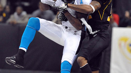 The Philadelphia Soul's Larry Brackins makes a reception in front of the Power's  Royce Adams during tonight's game at Consol Energy Center.