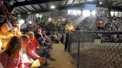 Roger VanDruff helps out by watching for bids during the 4-H Market at the Greene County Fair, which ended Saturday. The fair has many energy-related sponsors, including EQT Corp., Chevron, Consol Energy and Energy Corporation of America.