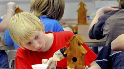 Anthony Raynes, 11, works on his birdhouse project during the South Elementary after-school boys club Gladiator Guys activities.