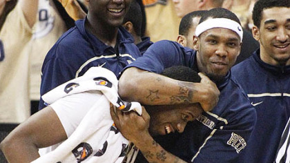 Pitt's J.J. Moore, right, hugs Lamar Patterson after a victory against West Virginia Thursday at the Petersen Events Center.