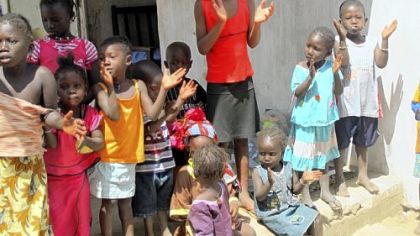 Children run out of their homes and start singing for money when they see tourists coming in Juffure.