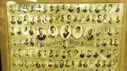 A framed photograph of the first graduating class of Schenley High School in 1918 is part of senior James Hill's collection of memorabilia.