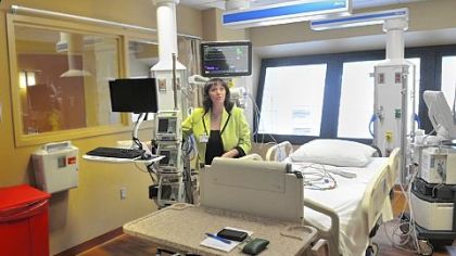 Angela Costa, AGH's director of the nursing division, explains the set-up of a room at Allegheny General Hospital's new neurosurgical ICU.