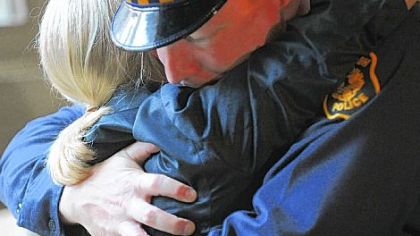 Officer Wade Sarver of Zone 4 embraces  prosecutor Lisa Pellegrini.