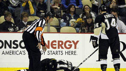 Penguins forward Chris Kunitz skates towards teammate Evgeni Malkin who lies injured on the ice during the second period of Friday's 3-2 win against the Sabres at Consol Energy Center.