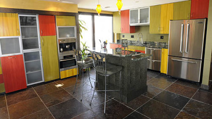 The kitchen features multi-colored panels on the cabinets.