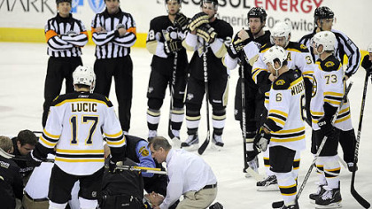 Bruins forward Marc Savard receives medical attention after taking a hit last March by Penguins forward Matt Cooke during a game at Mellon Arena.