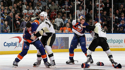 Islanders defenseman Travis Hamonic fights Penguins forard Mike Rupp (left) of as Islanders forward Josh Bailey battles Pascal Dupuis during the second period of Friday's game at Nassau Coliseum.