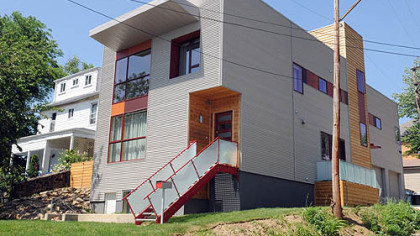 The exterior features a cut-out notch for the front door and frosted panels along the steps.