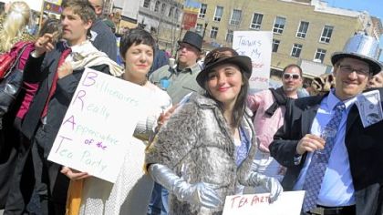 From left, Colin Anderson, 23, Julia Watkins, 24, Faith Auden, 19, and Zach Zobrist, 33, dress as billionaires at the tax day rally in Market Square on Friday. They said they were present  to "thank" the tea party for its support in extending the Bush tax cuts for the wealthy and maintaining plenty of tax loopholes for corporations and wealthy individuals.