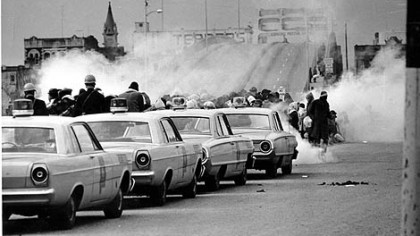 As the march began on March 7, 1965, Alabama state troopers fired tear gas on participants at the Edmund Pettus Bridge in Selma, then assaulted the marchers with clubs and whips.