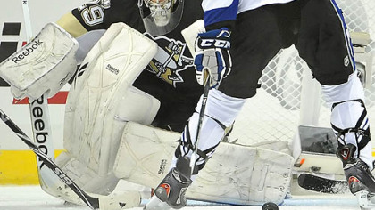 Penguins goaltender Marc-Andre Fleury makes a save on Lightning goaltender Vincent Lecavalier in the third period of Wednesday's game at Consol Energy Center.