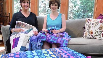 Darvina Emmerich and Chris Mabon, both widowed, now make blankets for chemotherapy patients as part of a project called "Wrapped in Love." Mrs. Emmerich was inspired to make blankets because her late husband was always cold during his chemo treatments.