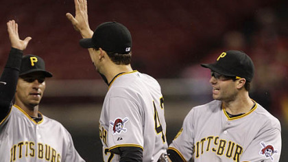 Pirates pitcher Charlie Morton, center, is congratulated by second baseman Neil Walker, right, and shortstop Ronny Cedeno following Friday's game at Great American Ballpark in Cincinnati.