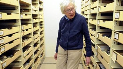 Longtime paleontologist at the Carnegie Museum of Natural History, Mary Dawson, looks through the shelves of skeletons at the museum.